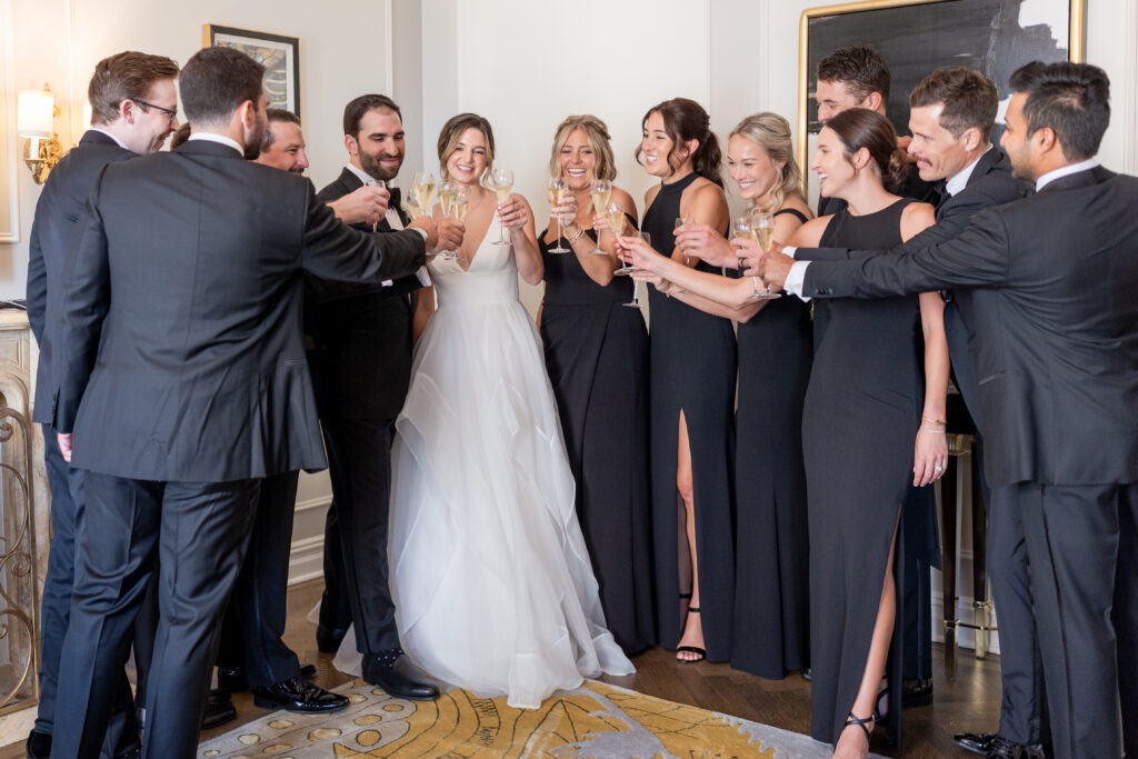 Plaza Hotel - bride, groom, and wedding party champaign cheer in bridal suite