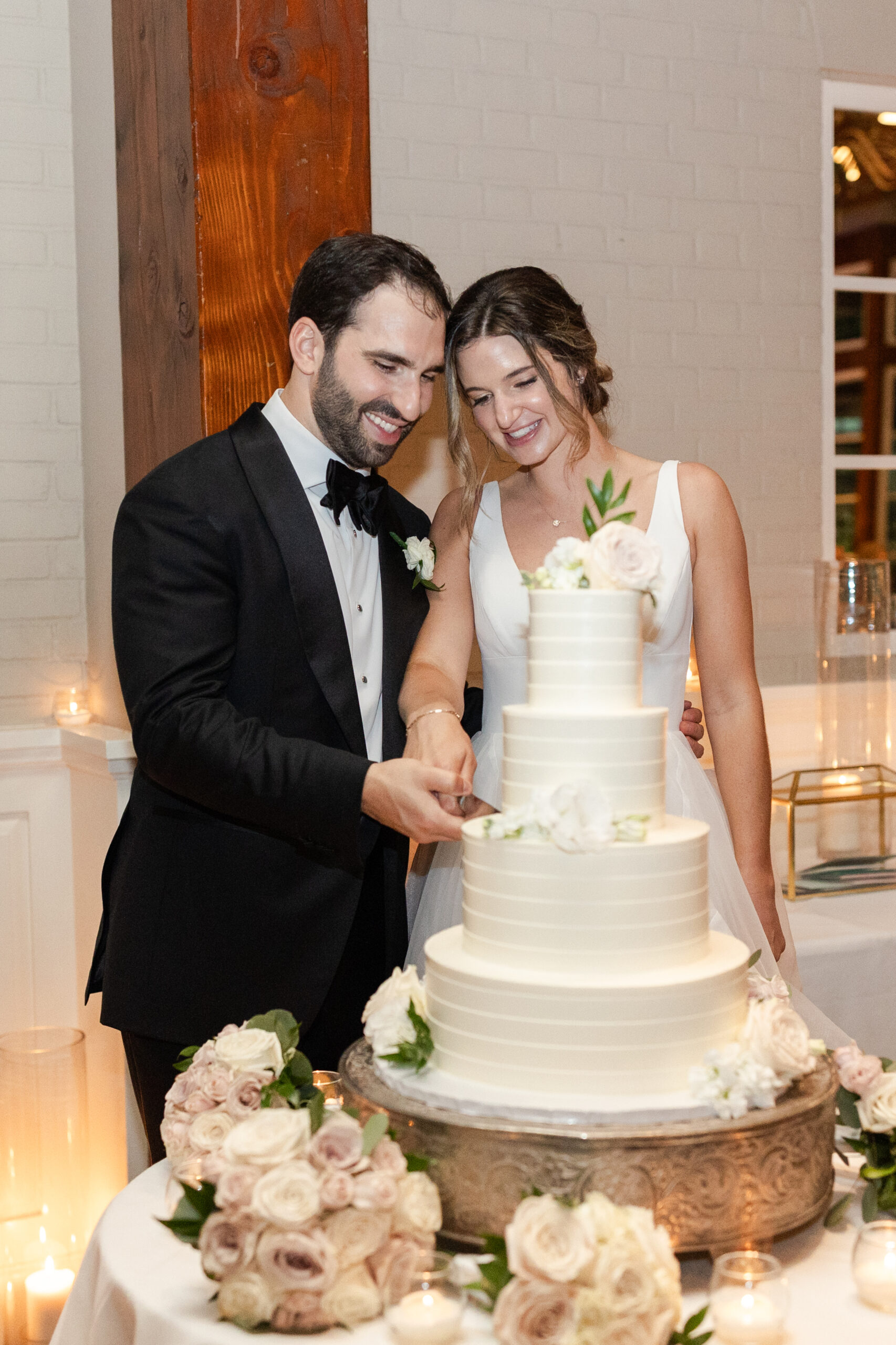 Bride and Groom cutting cake at indoor NYC wedding reception