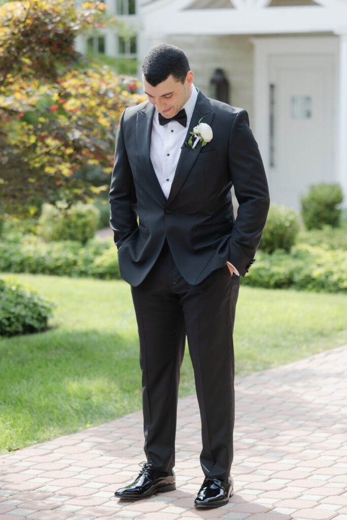 Groom first look outside of the Ryland Inn wedding venue, northern New Jersey