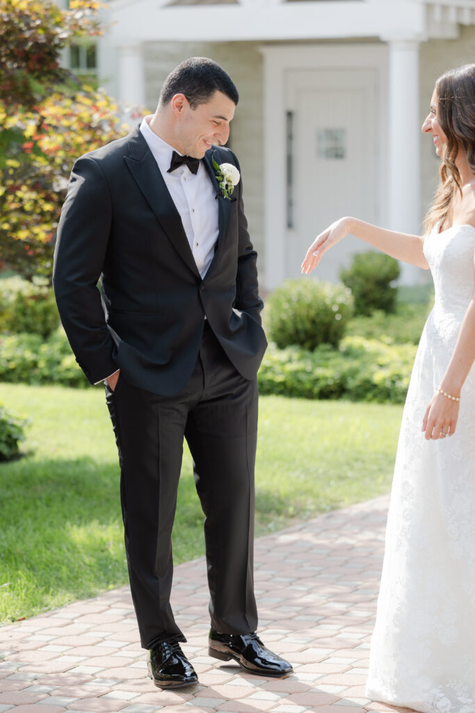 Groom first look outside of the Ryland Inn wedding venue, northern New Jersey