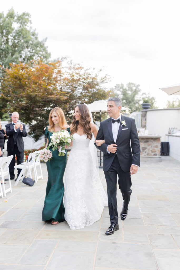 Bride and parents walking down the aisle moment