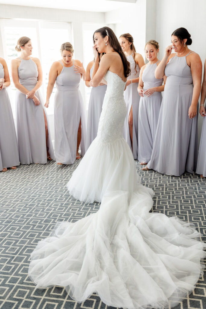 Bride and bridesmaid first look inside clubhouse wedding venue