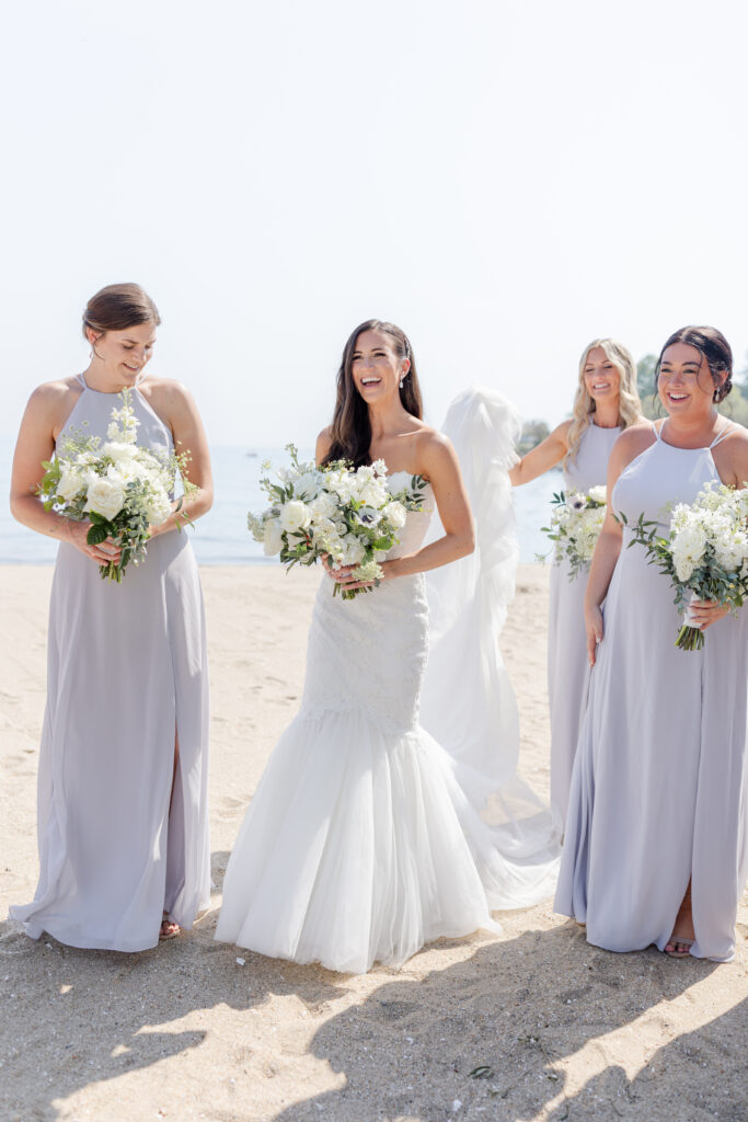 Bridal party portraits on the beach outside of the clubhouse wedding venue