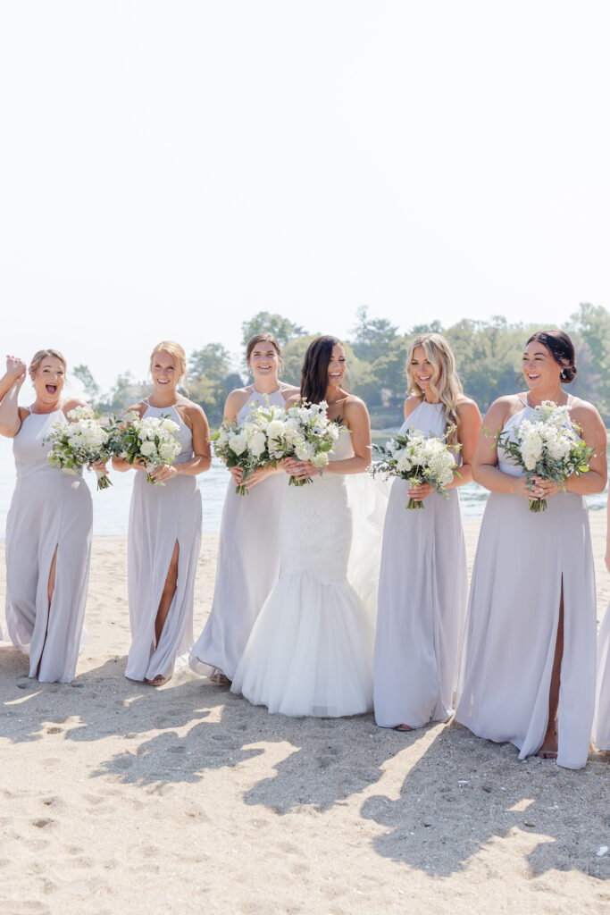 Bridal party portraits on the beach outside of the clubhouse wedding venue