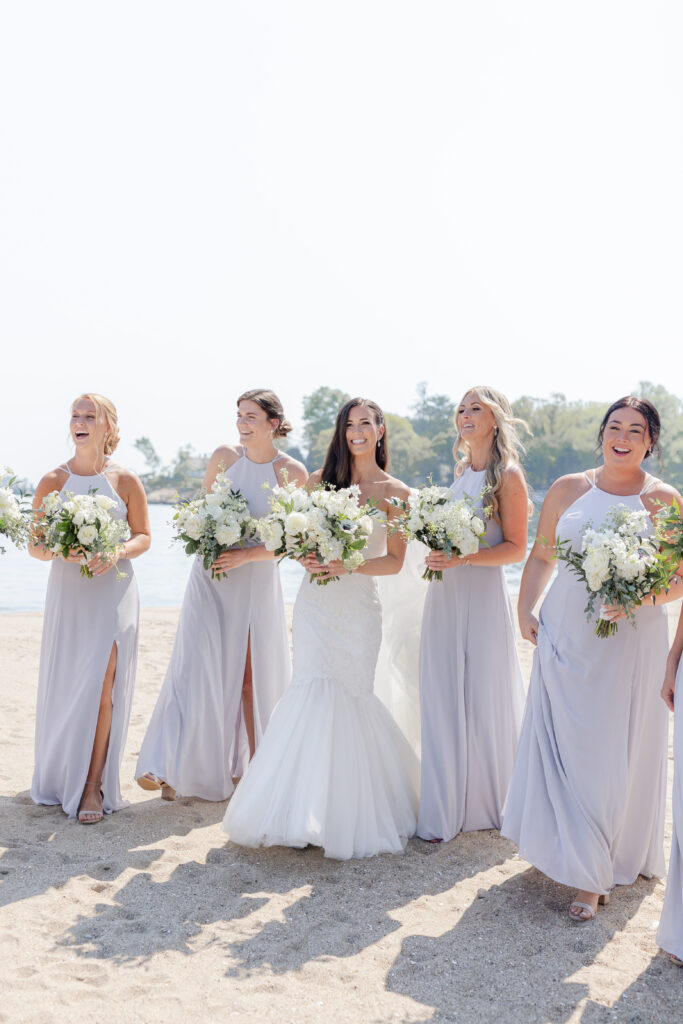 Bridal party portraits on the beach outside of the clubhouse wedding venue