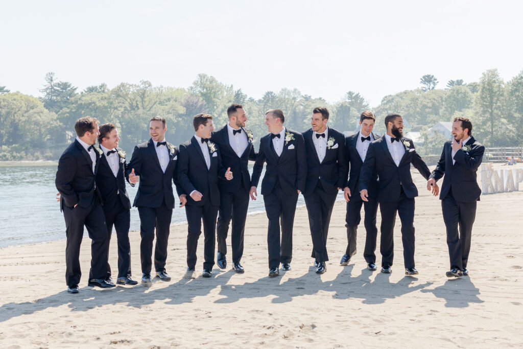 Groomsmen wedding party portraits outside of the clubhouse wedding venue on the sand