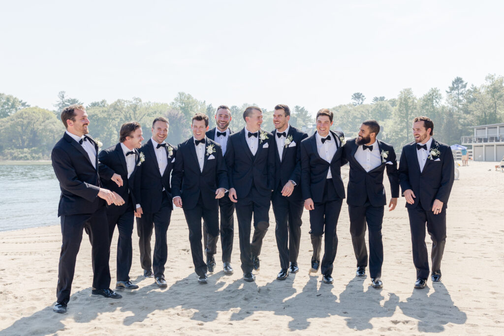 Groomsmen wedding party portraits outside of the clubhouse wedding venue on the sand