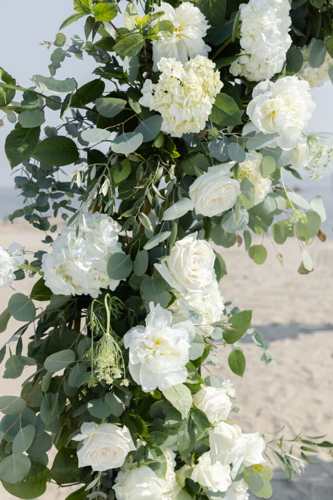 Wedding ceremony with centerpieces details and a water backdrop