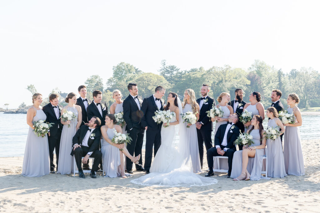 Full wedding party portraits outside of the clubhouse wedding venue on the sand