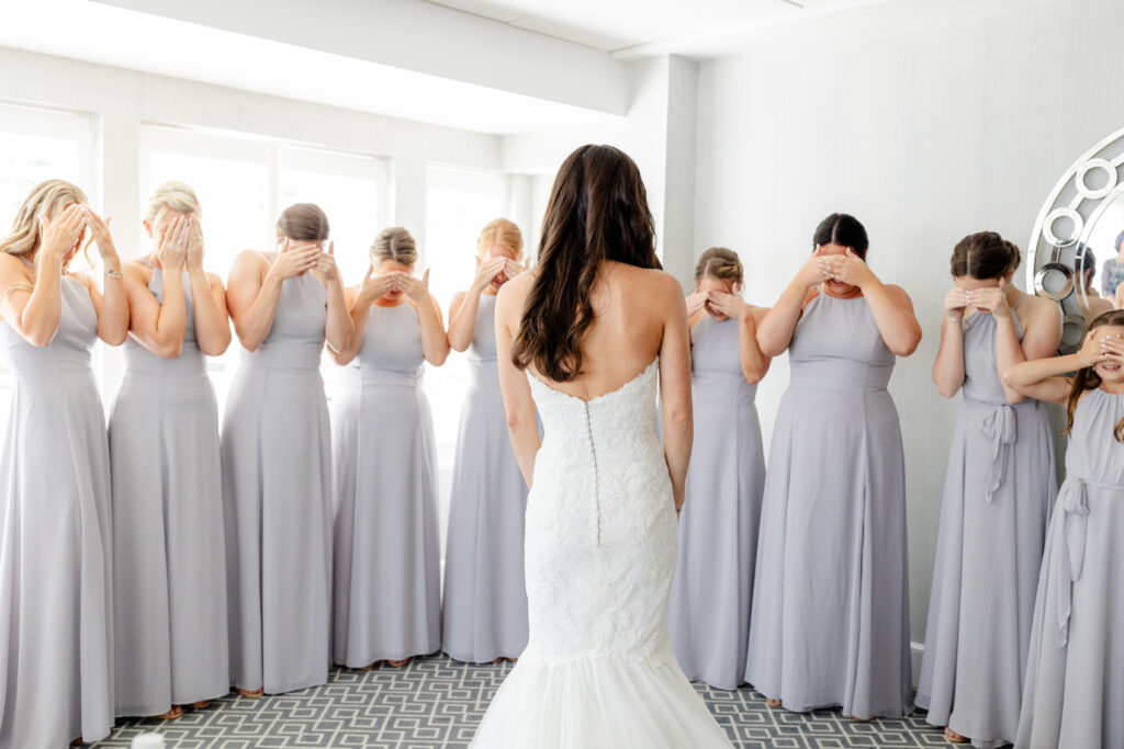 Bride and bridesmaid first look inside clubhouse wedding venue