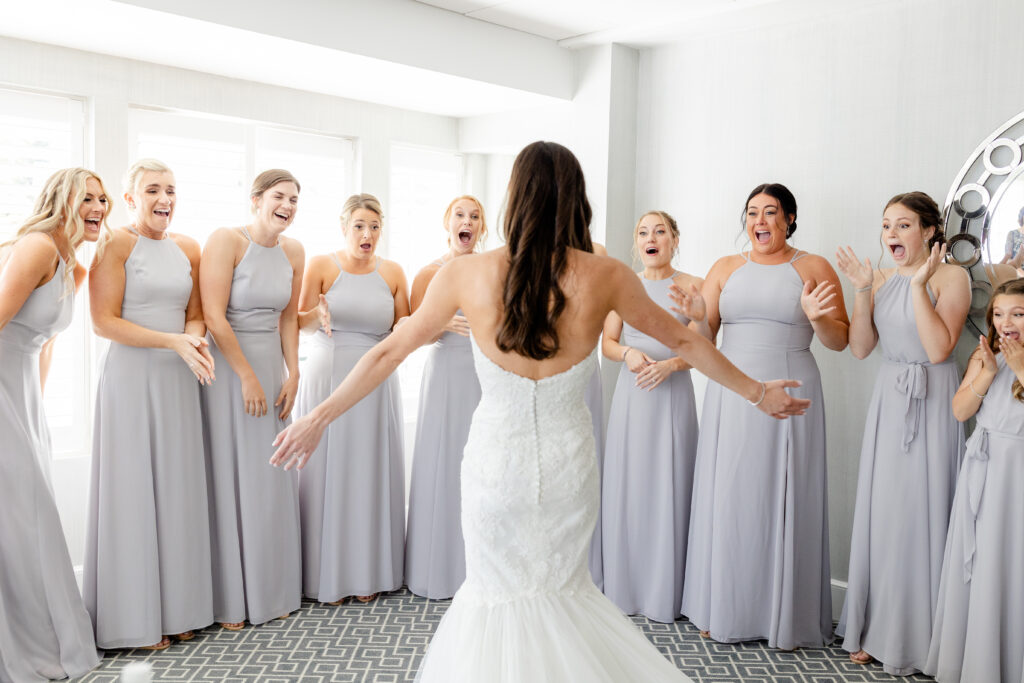 Bride and bridesmaid first look inside clubhouse wedding venue