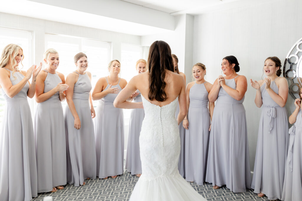 Bride and bridesmaid first look inside clubhouse wedding venue