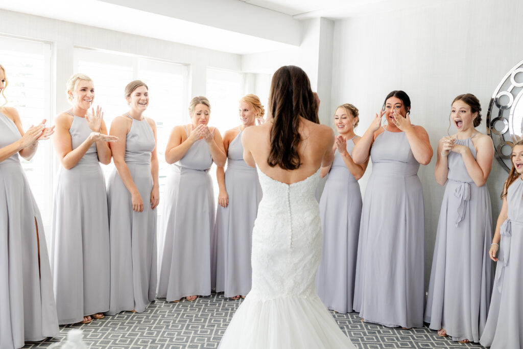 Bride and bridesmaid first look inside clubhouse wedding venue