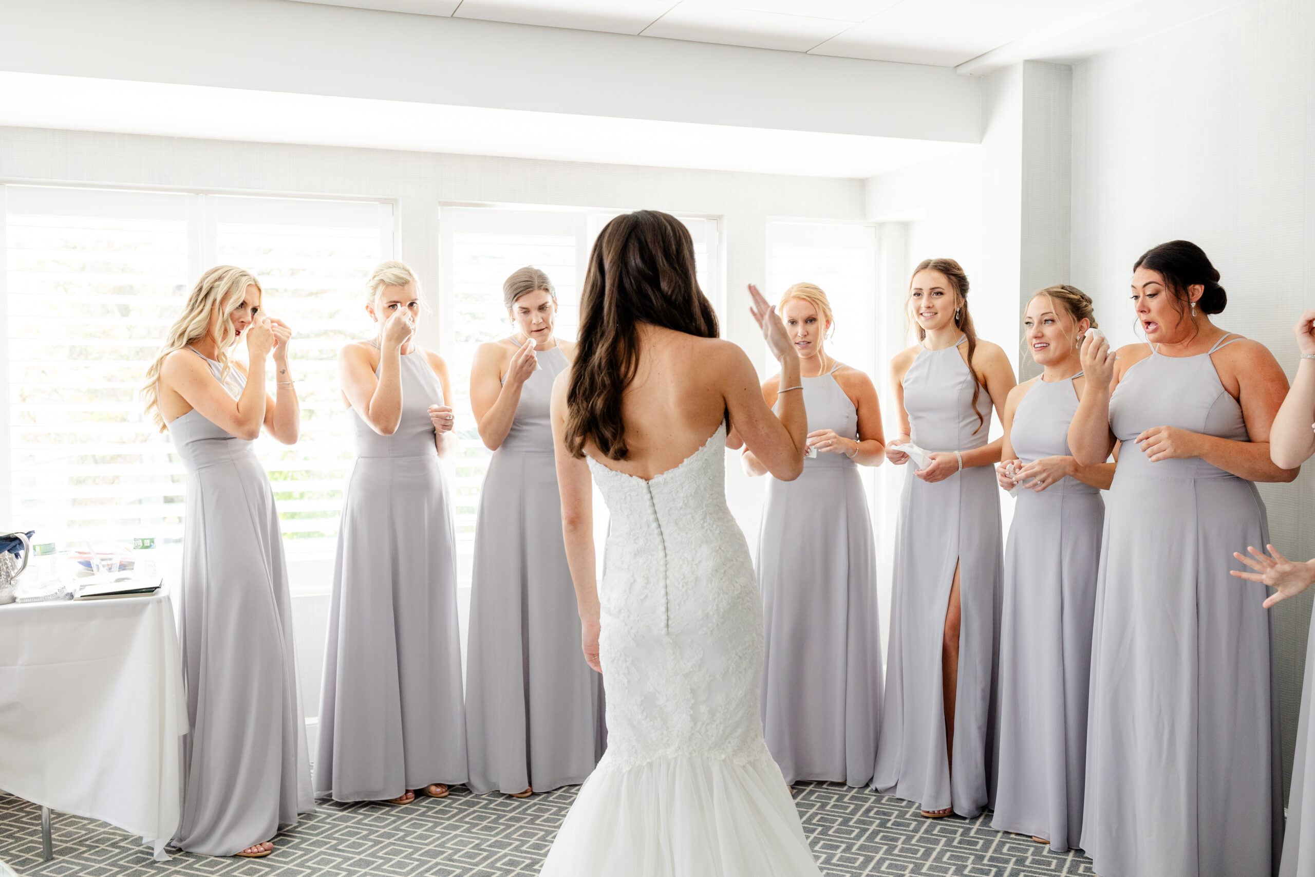 Bride and bridesmaid first look inside clubhouse wedding venue