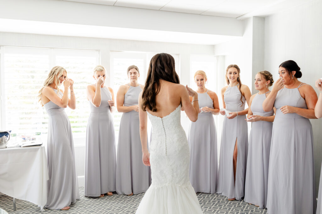 Bride and bridesmaid first look inside clubhouse wedding venue