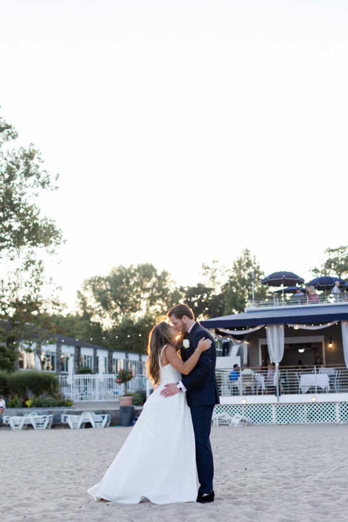 Bride and groom sunset photos in front of beach club