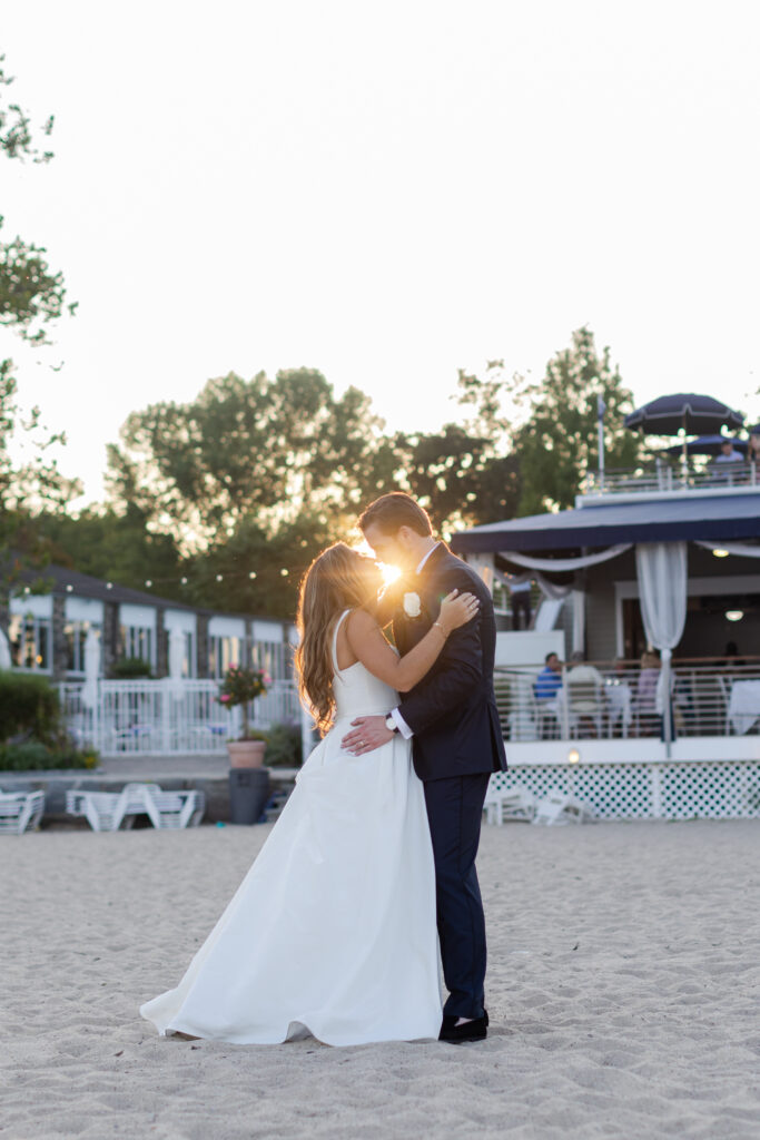 Bride and groom sunset photos in front of beach club