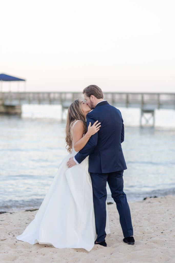 Bride and groom sunset photos on the sand with purple skies 