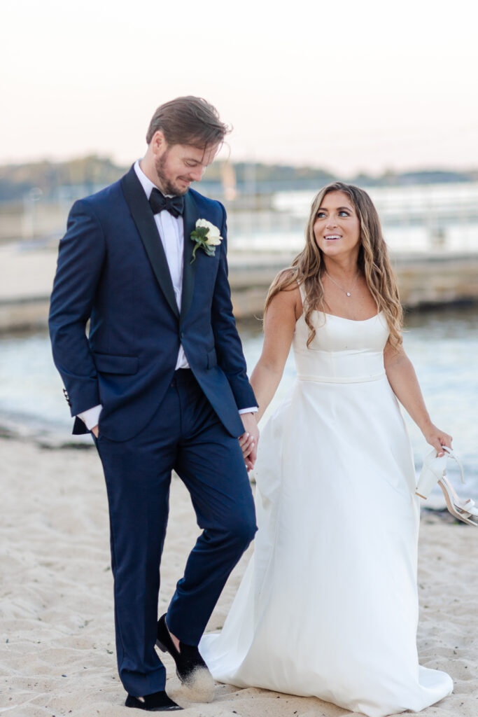 Bride and groom sunset photos on the sand with purple skies 