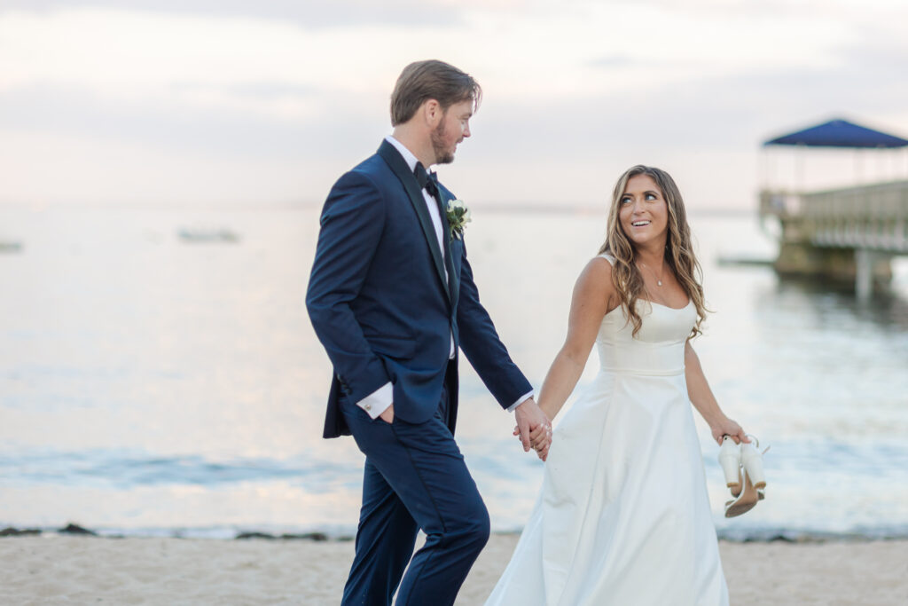 Bride and groom sunset photos on the sand with purple skies 