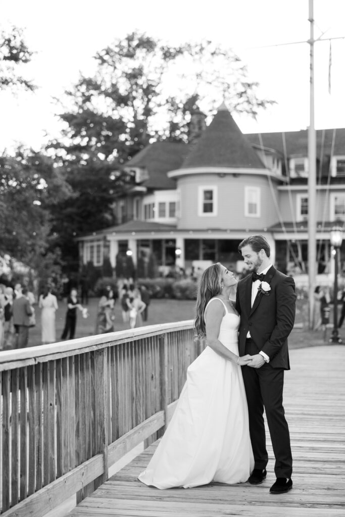 Bride and groom on bridge in front of Orienta Beach Club