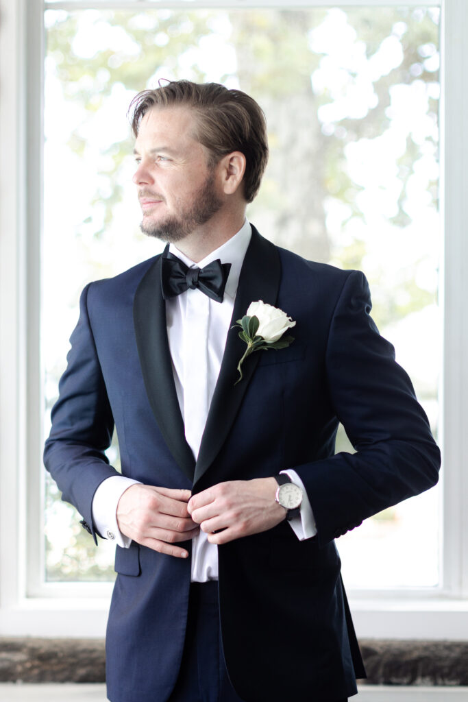 Groom getting ready inside clubhouse wedding venue