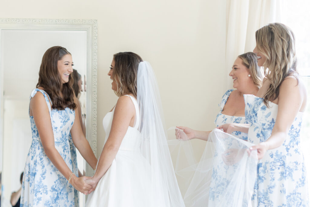 Bride getting ready in bridal suite with bridesmaid inside beach club wedding venue