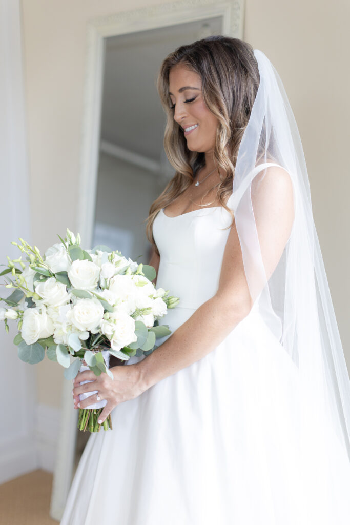 Bride portraits with bouquet inside bridal suite of Orienta Beach Club