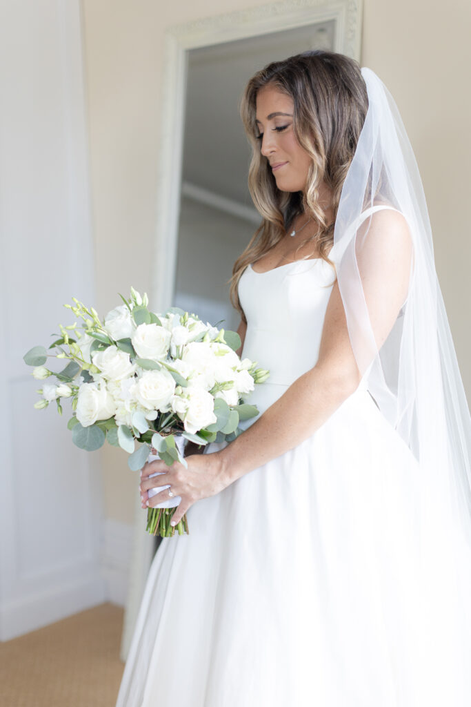 Bride portraits with bouquet inside bridal suite of Orienta Beach Club