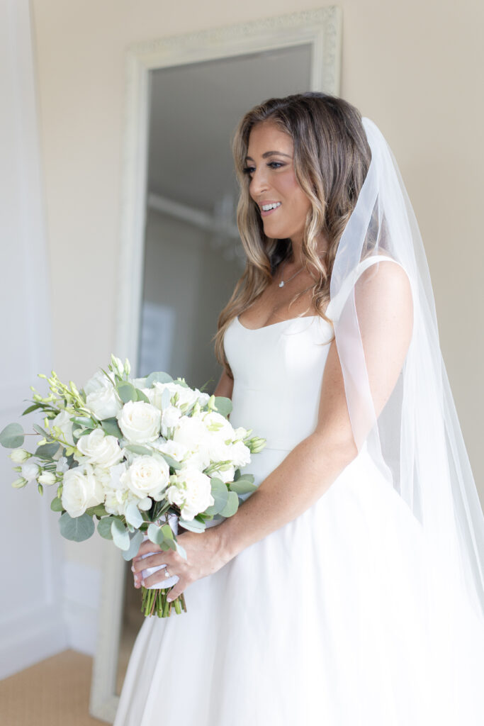 Bride portraits with bouquet inside bridal suite of Orienta Beach Club