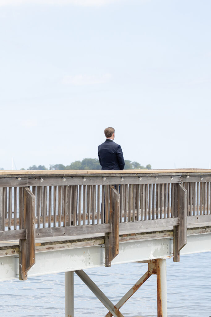 Bride and groom first look at bridge outside of clubhouse wedding venue