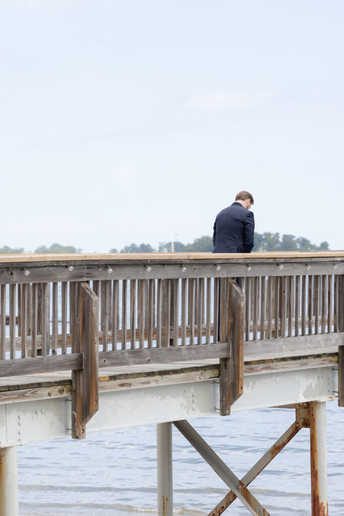 Bride and groom first look at bridge outside of clubhouse wedding venue