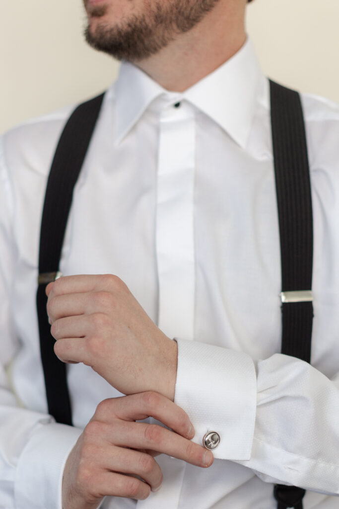 Groom getting ready with close up cufflinks