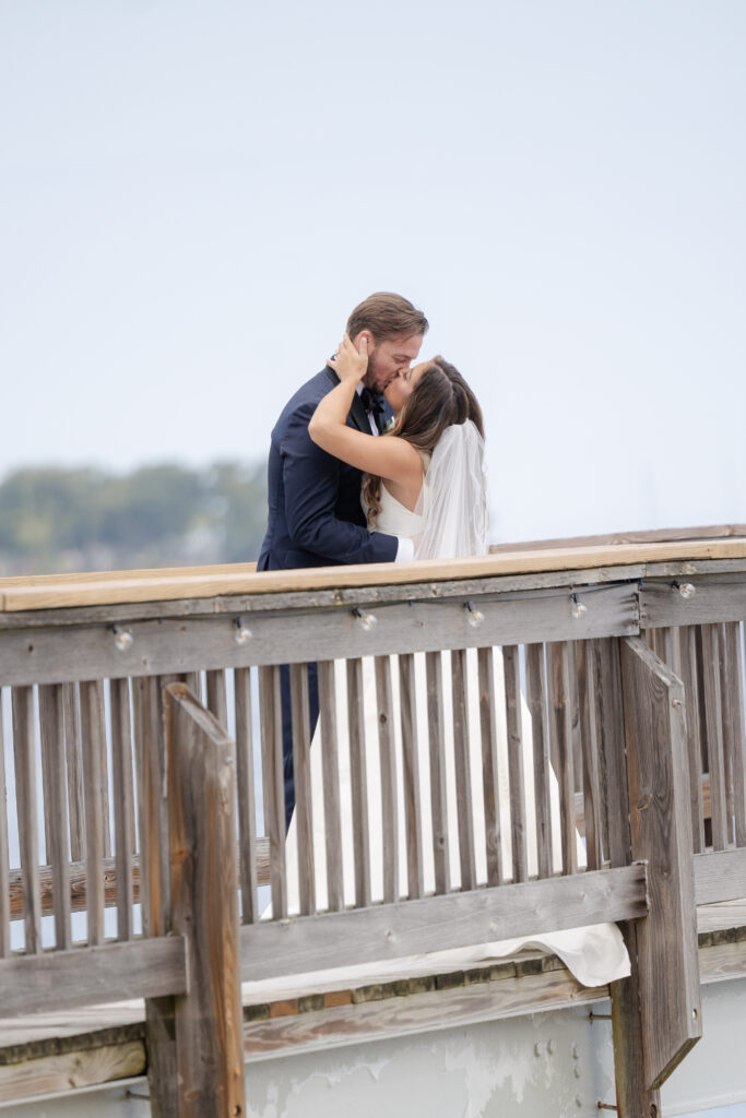 Bride and groom first look at bridge outside of clubhouse wedding venue