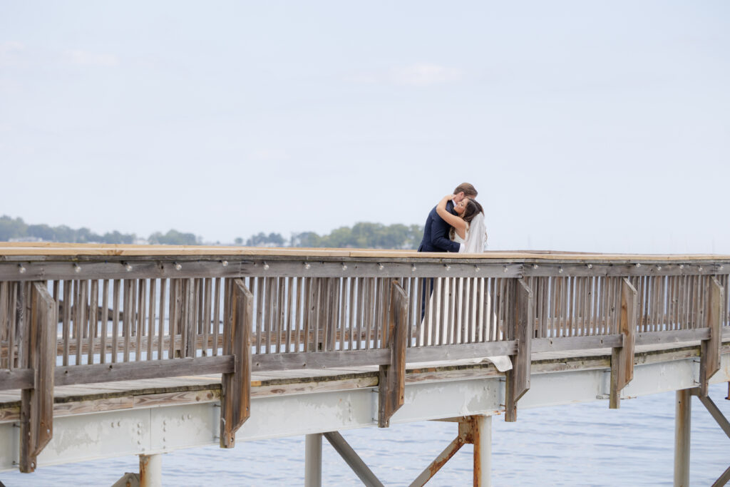 Bride and groom first look at bridge outside of clubhouse wedding venue