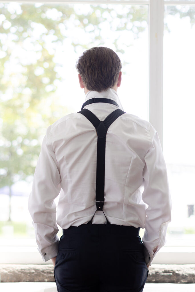 Groom getting ready inside beachfront wedding venue