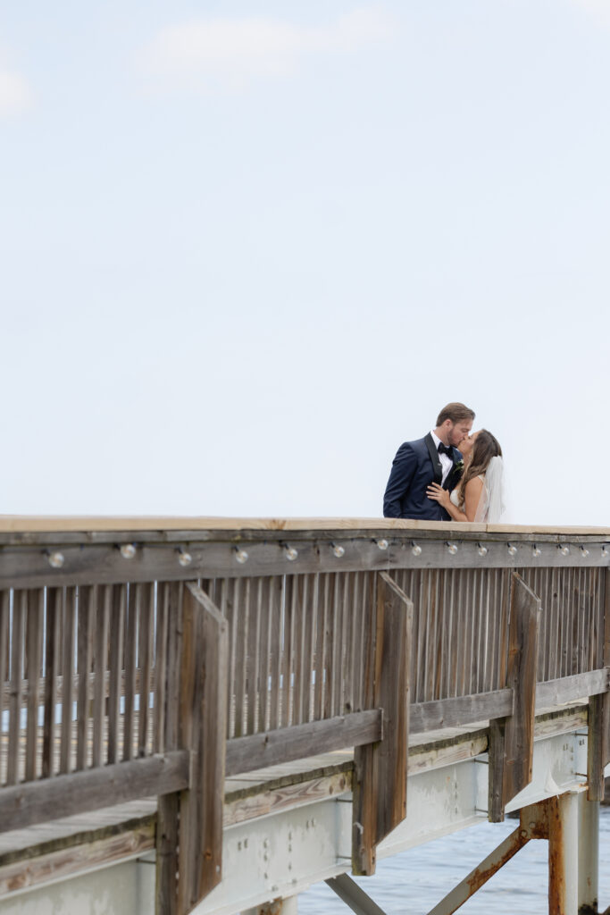 Bride and groom first look at bridge outside of clubhouse wedding venue