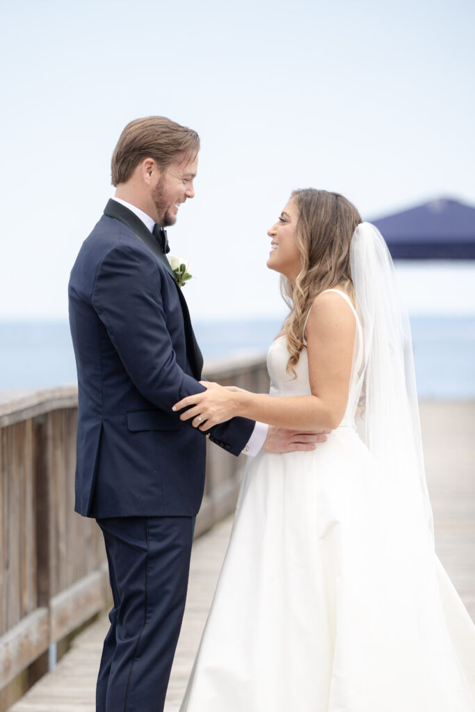 Bride and groom first look at bridge outside of clubhouse wedding venue