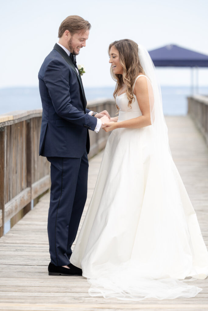 Bride and groom first look at bridge outside of clubhouse wedding venue