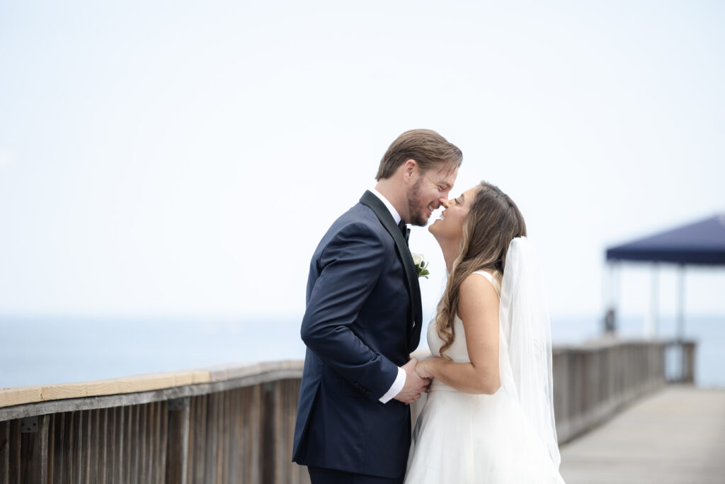 Bride and groom first look at bridge outside of clubhouse wedding venue