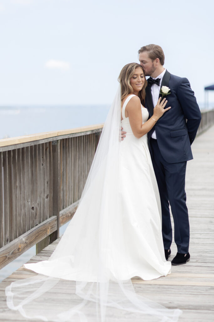 Bride and groom first look at bridge outside of clubhouse wedding venue