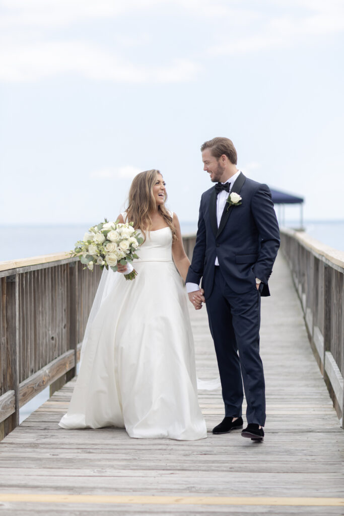 Bride and groom first look at bridge outside of clubhouse wedding venue