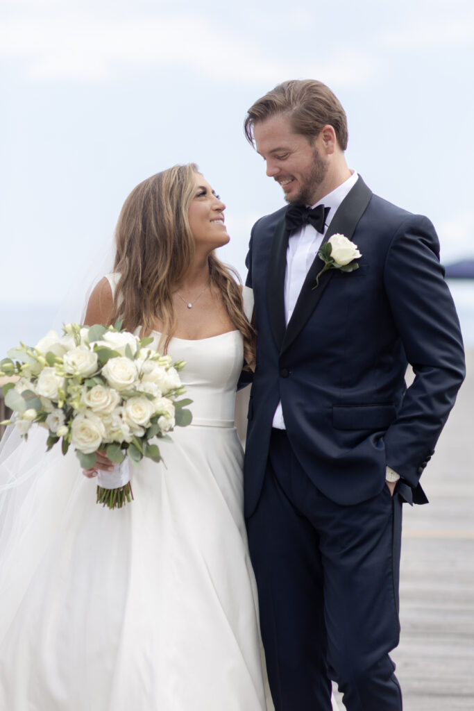 Bride and groom first look at bridge outside of clubhouse wedding venue