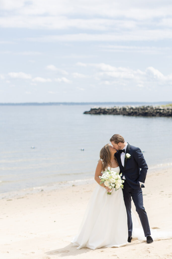 Bride and groom portraits on the beach outside wedding venue