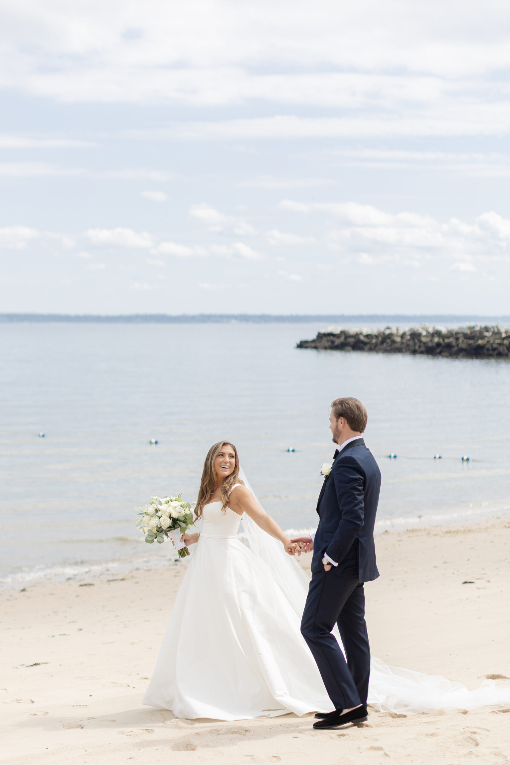 Bride and groom portraits on the beach outside wedding venue