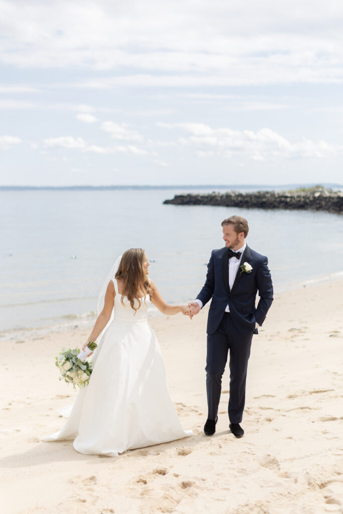 Bride and groom portraits on the beach outside wedding venue