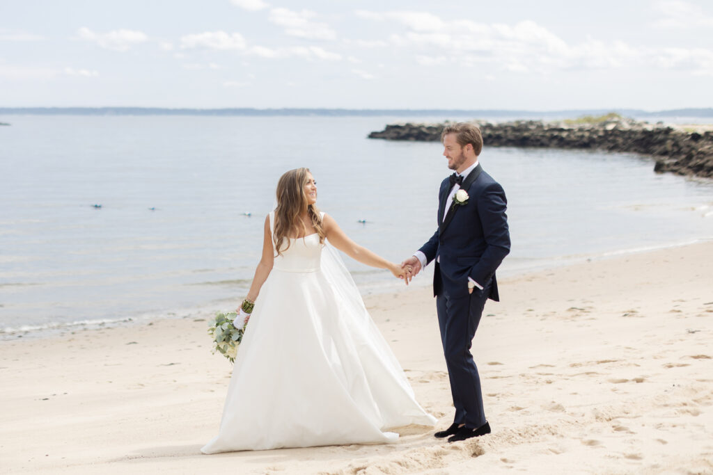 Bride and groom portraits on the beach outside wedding venue