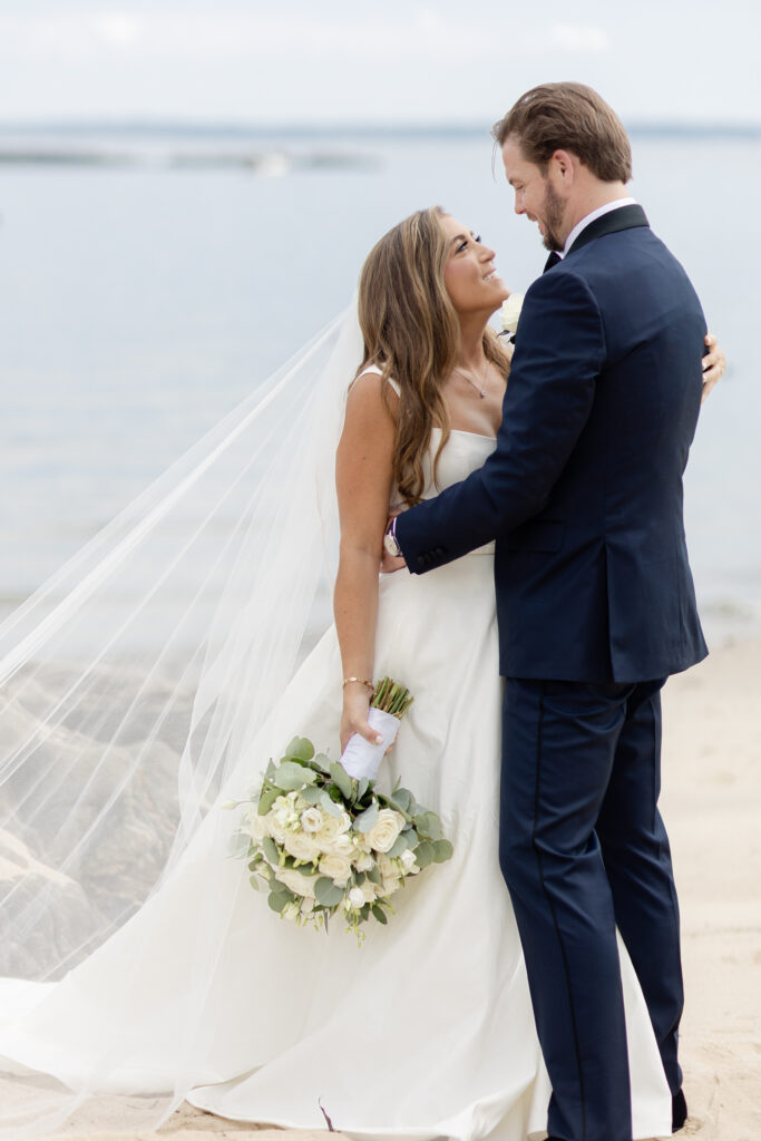 Bride and groom portraits on the beach outside wedding venue