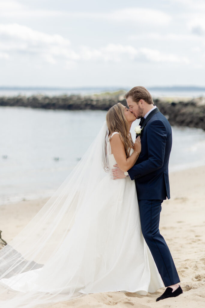 Bride and groom portraits on the beach outside wedding venue