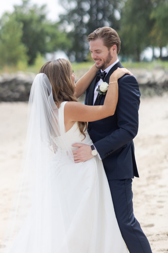 Bride and groom portraits on the beach outside wedding venue